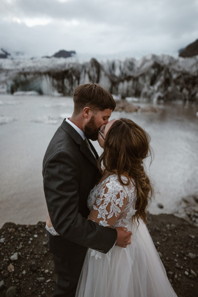 A couple kissing in front of a glacier in Iceland