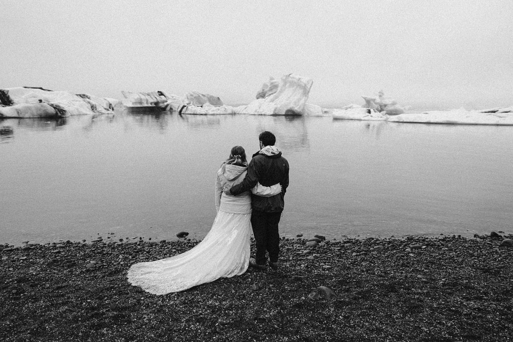 A couple stands together during their Iceland elopement