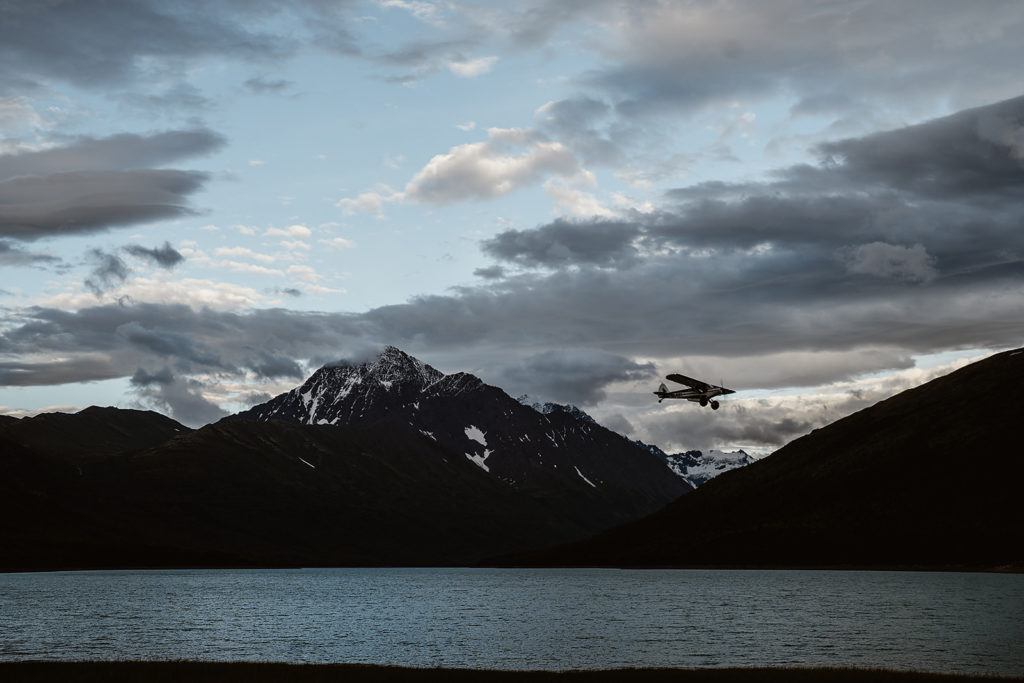 A plane flies over the Alaska backcountry