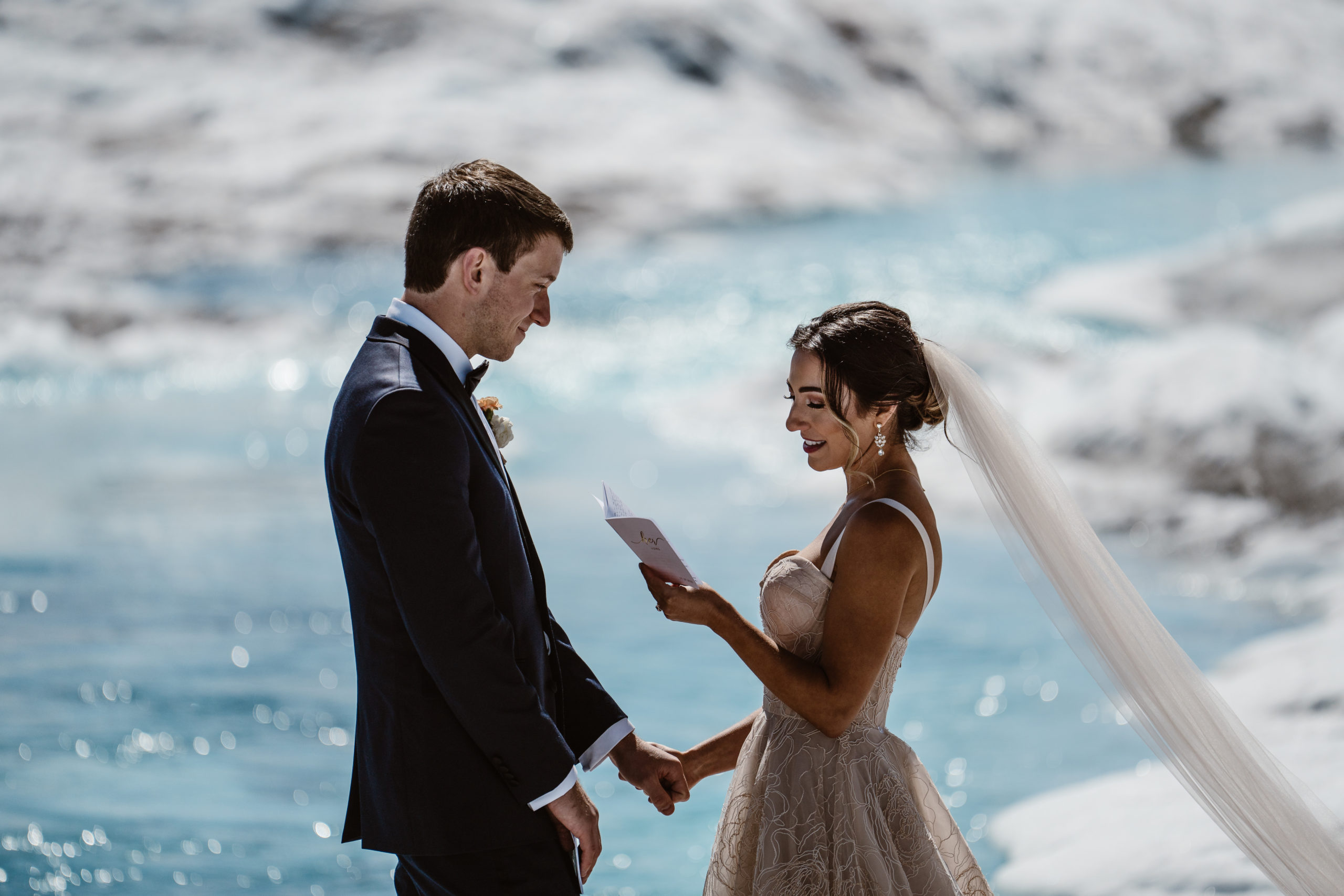 A couple reads their wedding vows at their Alaska elopement.