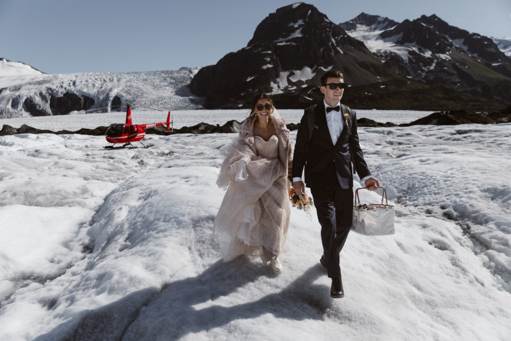 A couple walks together in the Alaska backcountry during their Alaska elopement