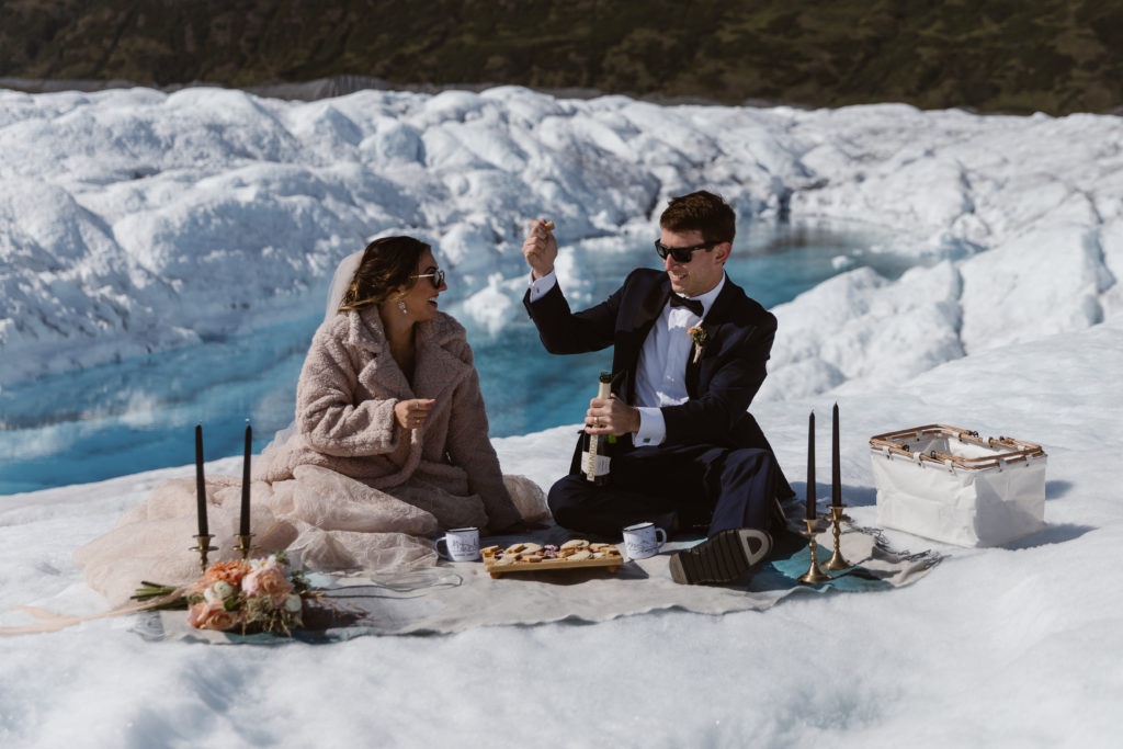 A couple has a picnic on a glacier during their Alaska elopement