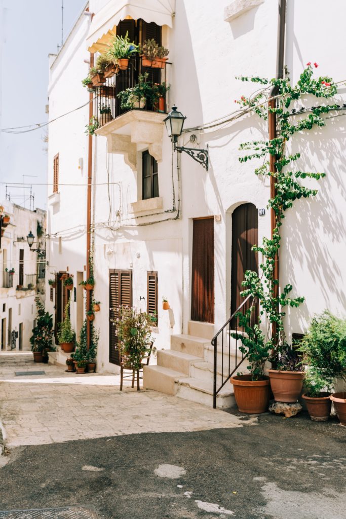 White homes with green plants in Puglia, Italy