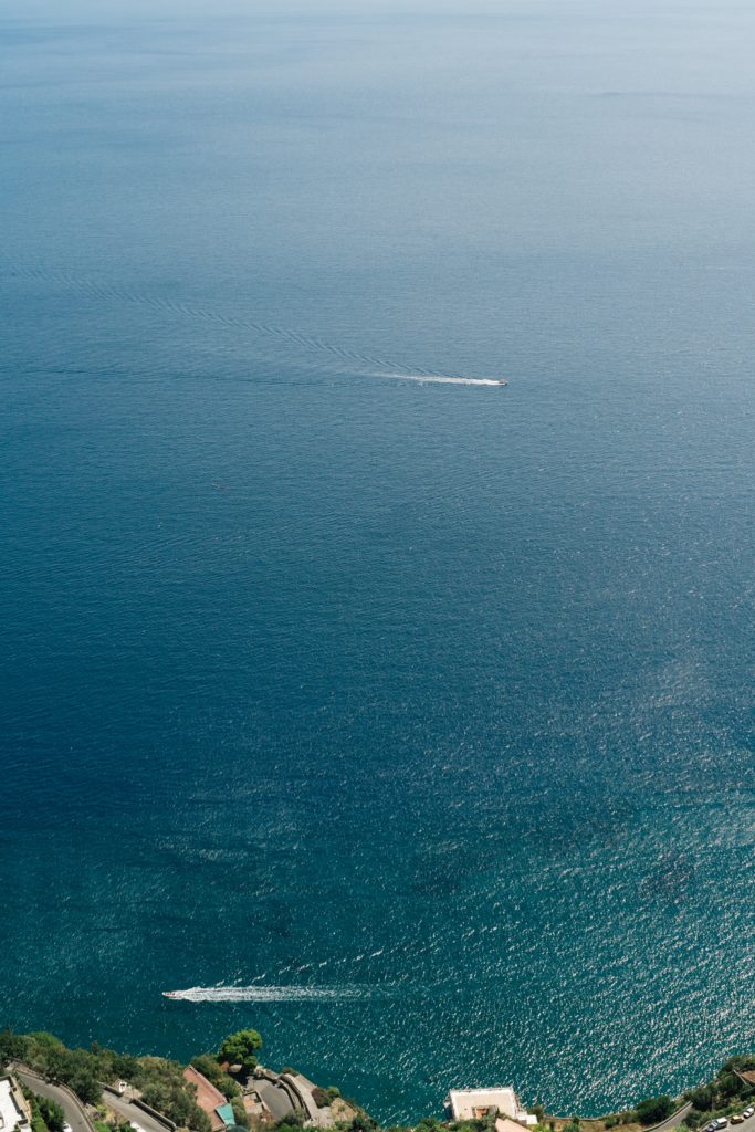 A boat cruises off the Amalfi Coast