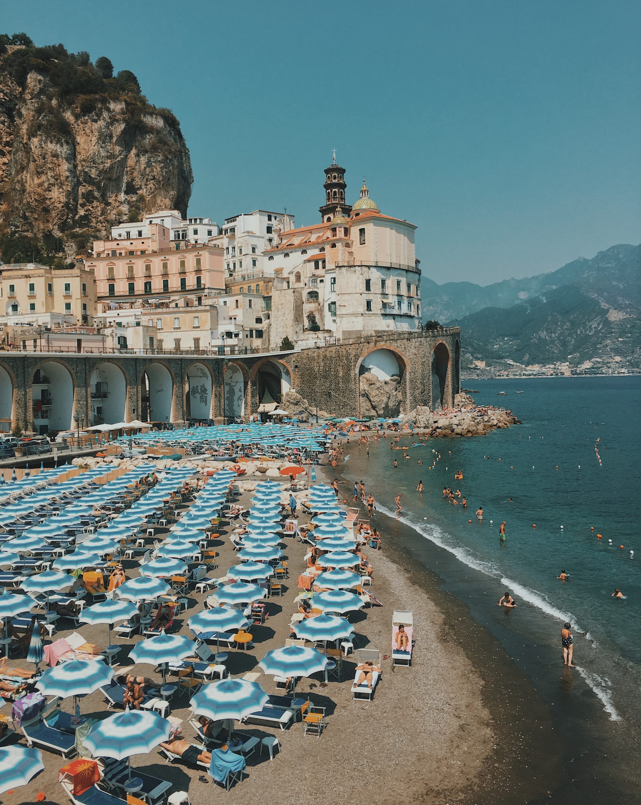 BLue umbrellas line the beach in Amalfi on the Amalfi Coast