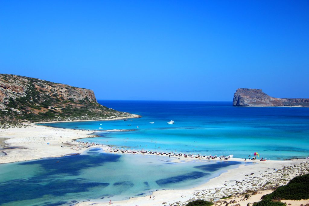 A thin sandbar runs between crystal blue waters at Balos Beach in Crete, Greece