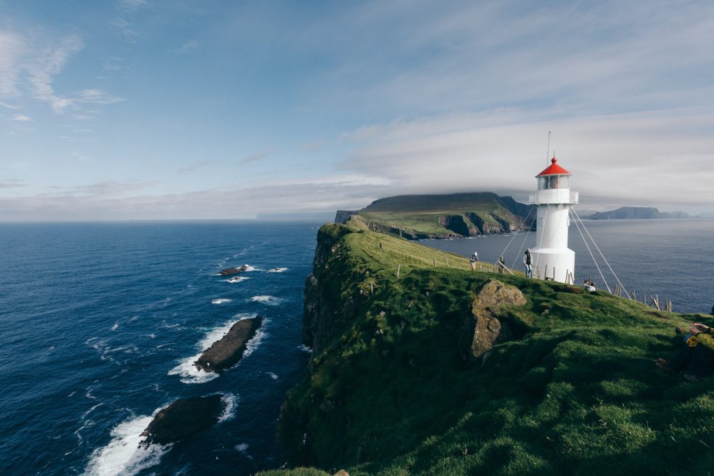 A white lighthouse on the coast of the Faroe Islands