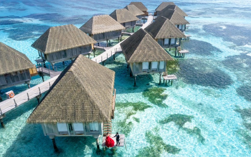 Overwater bungalows connected with a wooden pathway in the Maldives