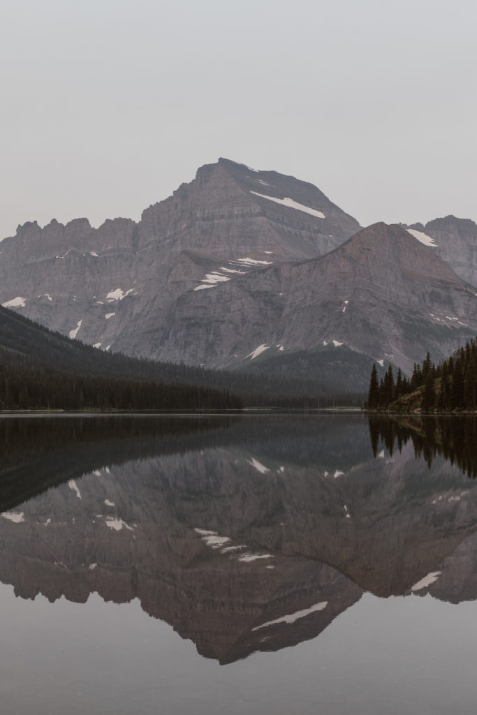 A tall mountain reflects in the lake below
