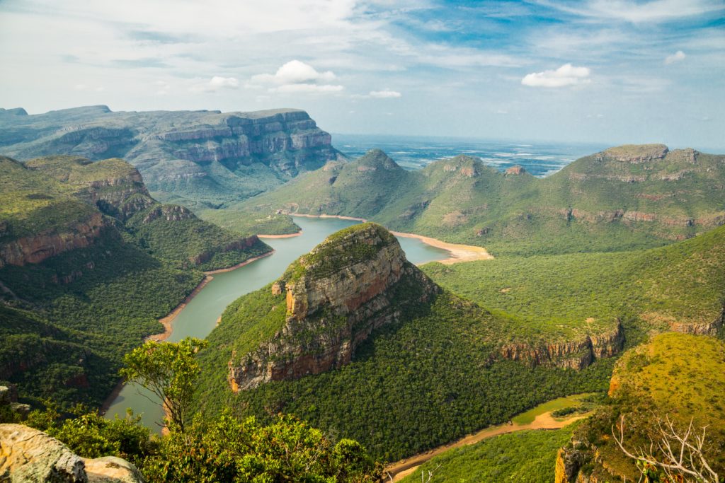 An aerial view of mountains, with a lake running through the valley, in South Africa