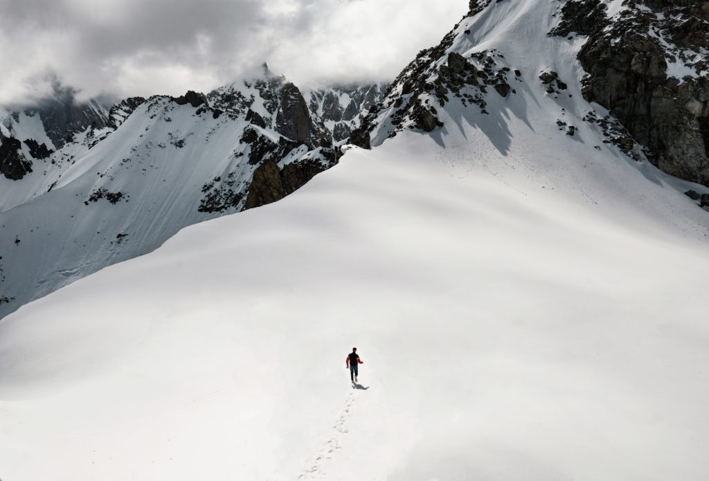 A man walks through snow near the peak of Mont Blanc