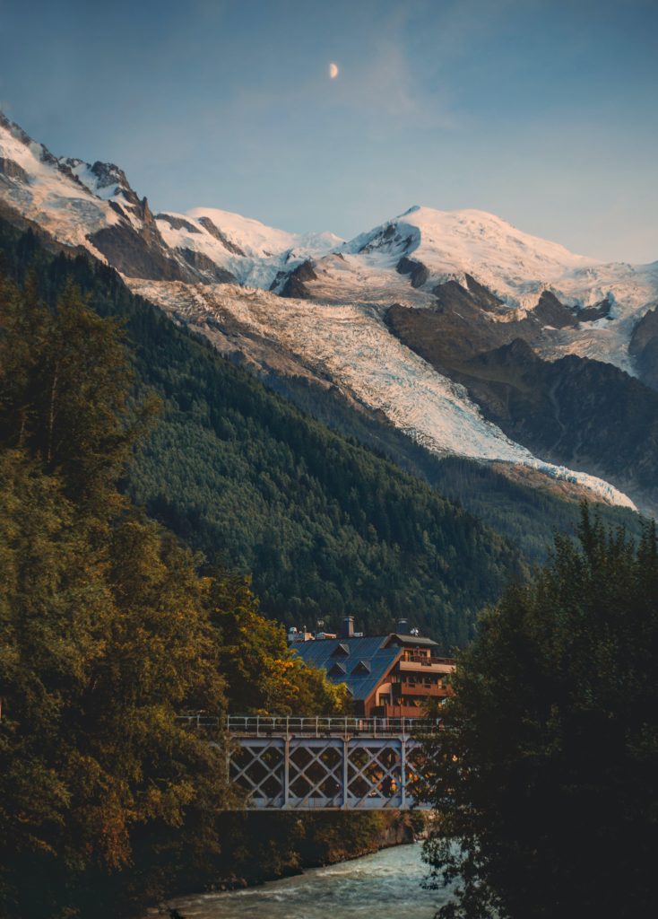 Snow-capped Mont Blanc rises over a small cabin in the summer